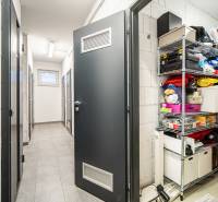 A hallway in a 2-room apartment with storage space and white walls.