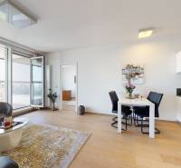 A bright living space with a balcony, wooden decor flooring in a 3-room apartment.
