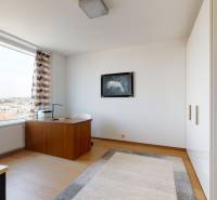 A study in a 3-room apartment with a wooden decor floor and a large window.