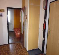 Interior of a 1-bedroom apartment with a wooden decor floor and simple furnishings.