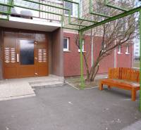 Entrance on Čergovská Street with a bench, ideal for a 2-room apartment in a panel building.