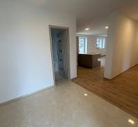 Interior of a family house with a wooden decor floor and light walls.