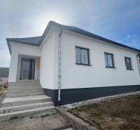 A family house in Sasinkovo on Sasinkovo Street with a white facade and a staircase.