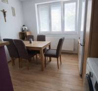 Dining room in a family house with a wooden decor floor and a dining table.