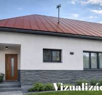 A family house in Oščadnica with a red roof and a modern entrance, surrounded by greenery.