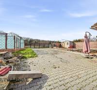 A courtyard in the village of Vrakúň with paving and building materials. Land - residential.