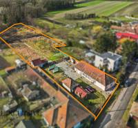 Plots for residential use in Vrakúňa, with a large yard and family houses in the background.