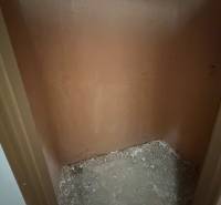 A small empty space with bare walls and a raw floor in a 3-room apartment.