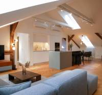 Attic interior with a kitchen, sofa set, and wooden decor flooring, 3-room apartment.