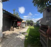 A family house in Dolné Orešany with an outdoor seating area and a garden fireplace.