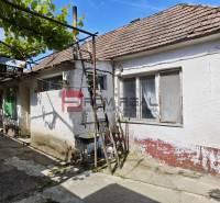 The exterior of an older family house in Dolné Orešany with a covered gallery.