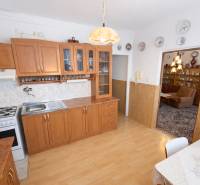 A kitchen in a 3-room apartment with wooden decor and rustic furniture.