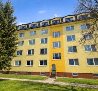 Apartment building on Liberation Square in Senica with a colorful facade and greenery.