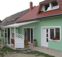 A family house on Mieru Street in Poproč with a terrace and a pink roof.