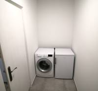 Washing machine and refrigerator on light tiles in a 3-room apartment.