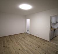 Living room connected to the kitchen, floor with wood decor, 3-room apartment.