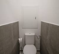 A toilet with ceramic tiles in a 3-room apartment.