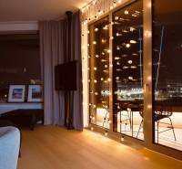 Interior of a 3-room apartment with light decoration, curtains, and a wooden decor floor.