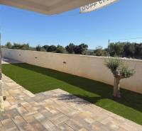 Stone terrace with artificial grass at a family house in Vrsi on Vrsi Street.