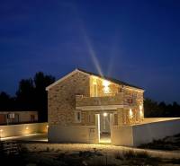 A family house on Vrsi Street in the town of Vrsi in a nighttime atmosphere with lighting.