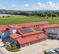 Commercial premises on Uhrovecká in Lednické Rovne with a parking lot and solar panels on the roof.
