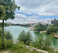 Lake with adjacent houses on Golf Street in Hrubá Borša in the picture.
