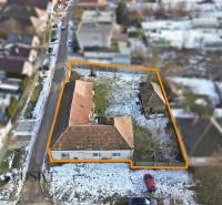 Winter shots of plots - housing in Zemné with a street, houses, and snow-covered roofs.