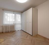 Interior of a spacious 3-room apartment with a wardrobe and wooden decor flooring.