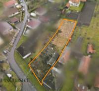 Aerial view of plots - housing in Holice with a garden and a road.