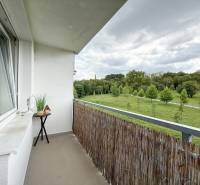 A balcony with a view of greenery in a 2-room apartment on Kvačalova Street in Žilina.