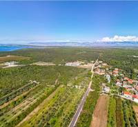 Aerial view of the landscape in PETRČANE with rural houses and fields near 2-bedroom apartments.