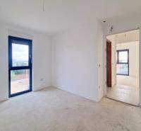Interior of a 3-room apartment with white walls and a large window.