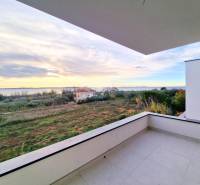 View from the balcony of a 3-room apartment in Privlaka, surrounded by meadows and the sea.