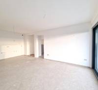 A spacious room in a 3-room apartment with large glass doors and light-colored walls.