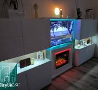 Cleverly designed living space in a 2-room apartment with a wooden decor floor.