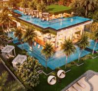 Luxury apartment development in Pattaya with a rooftop pool and tropical greenery.