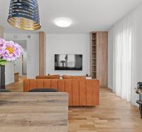 Living room in a 3-room apartment with an orange sofa and a wooden decor floor.