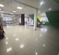 A spacious room in a family house with colorful walls and large windows.