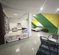 A bedroom in a family house with colorful walls and simple furniture.