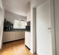 Recreational apartment with a kitchen, appliances, and a wooden decor floor.