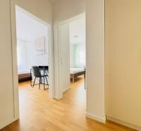 A bright hallway with a wood-patterned floor in a holiday apartment.