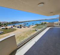 Balcony of a holiday apartment in Povljana with a view of the sea and the beach with boats.