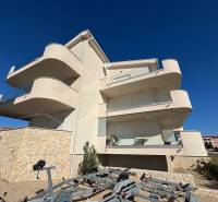 White facade of the Recreational Apartment in Povljana, terraces, and blue sky.