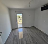Room in a recreational apartment with a large window and a view of the surroundings.
