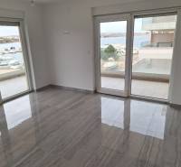 Interior of a holiday apartment with large windows and a view of the harbor.