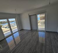Interior of a holiday apartment with large windows and a view of the Povljana coastline.
