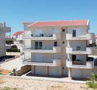 A recreational apartment in Povljana with balconies and a modern facade design.