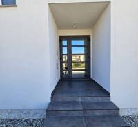 Entrance to the Recreational Apartment in Povljana with dark tiles and glass doors.