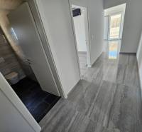 Recreational apartment with a bright hallway, tiles, and light walls.