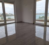 Interior of a holiday apartment with large windows and wood-decor flooring, sea view.